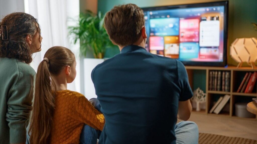 Family watching television together at home